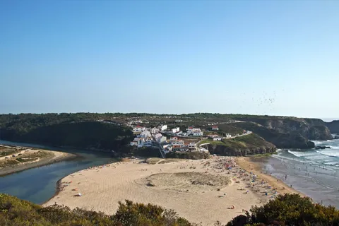 Aerial view of Praia de Odeceixe where a river meets the Atlantic on Portugal's west coast in June