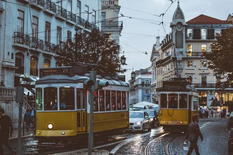 Yellow trams on a Lisbon street, one of the best places to live in Portugal for expats
